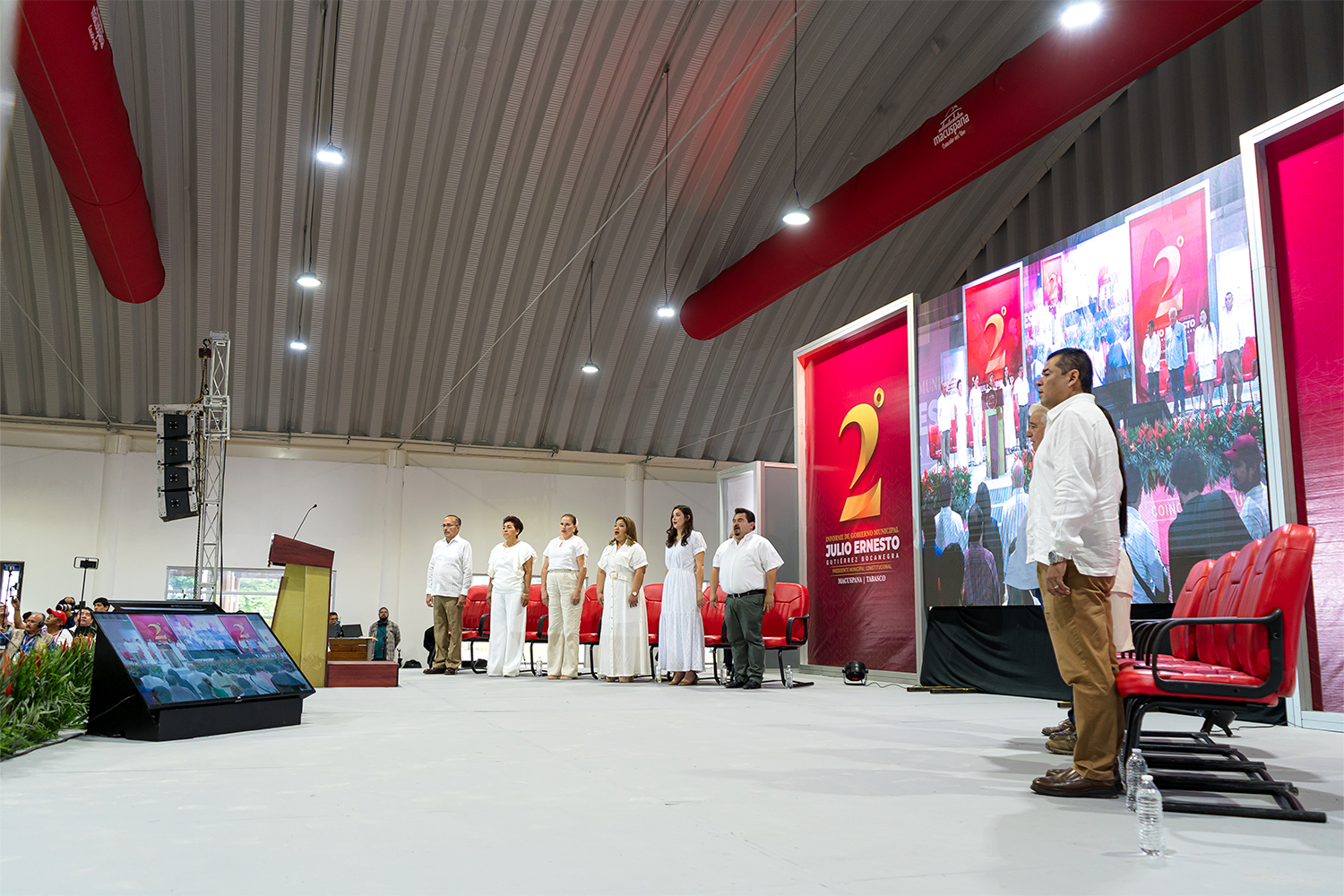 Alcalde Julio Ernesto Gutiérrez y presídium en el escenario principal durante el Segundo Informe de Gobierno de Macuspana.